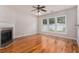 Open living room featuring hardwood floors, a fireplace, and large windows at 1576 Thornwick Trce, Stockbridge, GA 30281