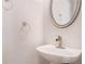 Clean powder room with a modern sink, round mirror, and neutral color scheme at 1576 Thornwick Trce, Stockbridge, GA 30281