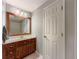 Traditional bathroom featuring a wooden-framed mirror and a white door at 2700 Pine Tree Ne Rd # 1013, Atlanta, GA 30324