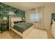 The bedroom features a tropical accent wall, a white bed frame, curtains, and plush carpet flooring at 2700 Pine Tree Ne Rd # 1013, Atlanta, GA 30324