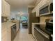 Bright kitchen with stainless steel appliances that opens to a comfortable living room area with a ceiling fan at 2700 Pine Tree Ne Rd # 1013, Atlanta, GA 30324