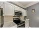 Kitchen featuring white cabinets, gray walls, white countertops, and stainless steel microwave at 2700 Pine Tree Ne Rd # 1013, Atlanta, GA 30324