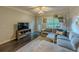 Cozy living room with gray sectional, dark wood floors, and lots of natural light at 2700 Pine Tree Ne Rd # 1013, Atlanta, GA 30324