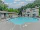 Community pool area with patio seating and view of a building behind it at 2700 Pine Tree Ne Rd # 1013, Atlanta, GA 30324