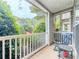 A cozy porch with outdoor furniture that faces a view of trees at 2700 Pine Tree Ne Rd # 1013, Atlanta, GA 30324