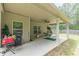 Covered back patio with outdoor seating, ceiling fan, and a grill; ideal for entertaining or relaxing outdoors at 446 Vandenburg Dr, Villa Rica, GA 30180