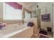 Bright bathroom features a soaking tub and a separate glass enclosed shower at 446 Vandenburg Dr, Villa Rica, GA 30180