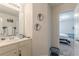 Bright bathroom with a single sink vanity and decorative seahorse wall art at 446 Vandenburg Dr, Villa Rica, GA 30180