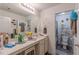 Well-lit bathroom with a large mirror, vanity and door that leads to a toilet and shower at 446 Vandenburg Dr, Villa Rica, GA 30180