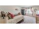 Bright bedroom with a comfortable bed, soft carpet, and natural light from the window at 446 Vandenburg Dr, Villa Rica, GA 30180