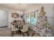 Bright dining area featuring modern chandelier, seating for four, and a large window with natural light at 446 Vandenburg Dr, Villa Rica, GA 30180