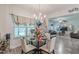 Cozy dining area featuring a glass table, white chairs, and chandelier lighting at 446 Vandenburg Dr, Villa Rica, GA 30180