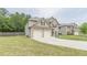 Brick and siding home with a green lawn and a two-car garage at 446 Vandenburg Dr, Villa Rica, GA 30180