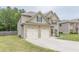 A home featuring a blend of brick and siding, complemented by a two-car garage and green lawn at 446 Vandenburg Dr, Villa Rica, GA 30180