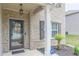 Charming front porch featuring a decorated door, manicured landscaping, and brick exterior, creating a welcoming entrance at 446 Vandenburg Dr, Villa Rica, GA 30180