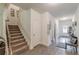 Hallway featuring neutral walls and flooring leading to the entry and staircase at 446 Vandenburg Dr, Villa Rica, GA 30180