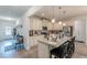 Open-concept kitchen with granite countertops, stainless steel appliances, and modern bar stool seating at 446 Vandenburg Dr, Villa Rica, GA 30180
