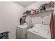 Functional laundry room equipped with a washer, dryer, and shelving for storage at 446 Vandenburg Dr, Villa Rica, GA 30180