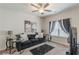 Comfortable living room with ceiling fan, large window, and modern decor at 446 Vandenburg Dr, Villa Rica, GA 30180