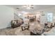View of open-concept living room with leather sofas and access to the kitchen and dining area at 446 Vandenburg Dr, Villa Rica, GA 30180