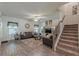 Living room featuring plush carpet, leather sofas and view to the staircase at 446 Vandenburg Dr, Villa Rica, GA 30180
