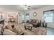 Living room with leather sofas, glass coffee table and view of dining area at 446 Vandenburg Dr, Villa Rica, GA 30180