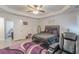Elegant main bedroom boasting a trey ceiling, luxurious bed, and adjacent sitting area at 446 Vandenburg Dr, Villa Rica, GA 30180