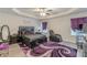 Luxurious main bedroom with a tray ceiling, elegant decor, and a cozy seating area at 446 Vandenburg Dr, Villa Rica, GA 30180