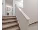 Carpeted staircase with white risers leading to the upper level of the home at 446 Vandenburg Dr, Villa Rica, GA 30180