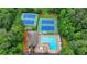 Aerial view of community pool, tennis courts and recreation area surrounded by mature trees at 5507 Martina Way, Dunwoody, GA 30338