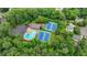 Aerial view of community amenities including a pool, tennis courts, and surrounding greenery at 5507 Martina Way, Dunwoody, GA 30338