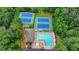 Aerial view showcasing the community amenities: tennis courts, pool, clubhouse, and a putting green at 5507 Martina Way, Dunwoody, GA 30338