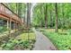Landscaped backyard featuring a stone path, well-maintained lawn, and a covered porch at 5507 Martina Way, Dunwoody, GA 30338