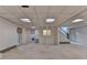 Large basement with neutral carpet, painted white walls, and a door for walkout access at 5507 Martina Way, Dunwoody, GA 30338