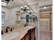 Bathroom featuring a double sink vanity with marble countertop, a large mirror, and elegant fixtures at 5507 Martina Way, Dunwoody, GA 30338