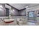Modern basement bathroom featuring a unique sink, stone accents, and a glass shower at 5507 Martina Way, Dunwoody, GA 30338