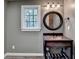 Elegant bathroom with a unique sink, updated lighting fixtures, and a dark framed mirror at 5507 Martina Way, Dunwoody, GA 30338