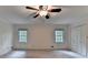 This bedroom features two windows, a ceiling fan, and closet space at 5507 Martina Way, Dunwoody, GA 30338