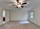 This bedroom features a ceiling fan, neutral walls, and a view into another room at 5507 Martina Way, Dunwoody, GA 30338