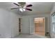 Spacious bedroom with white walls, ceiling fan, carpet floors and a large closet with an opened door at 5507 Martina Way, Dunwoody, GA 30338
