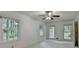 Bright and airy bedroom features three large windows overlooking mature trees at 5507 Martina Way, Dunwoody, GA 30338