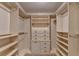 Spacious walk-in closet with custom built-in shelving and drawers, providing ample storage space at 5507 Martina Way, Dunwoody, GA 30338