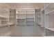 Large walk-in closet featuring custom shelving, hanging rods, and built-in storage for optimal organization at 5507 Martina Way, Dunwoody, GA 30338