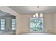 Bright dining room with a modern chandelier and views into an adjacent room at 5507 Martina Way, Dunwoody, GA 30338