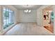 Bright dining room with large window, pendant lighting, and view into the kitchen at 5507 Martina Way, Dunwoody, GA 30338