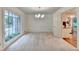 Bright dining room with large window, neutral carpet and chandelier at 5507 Martina Way, Dunwoody, GA 30338