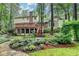 Charming backyard with a multi-level deck, mature trees, and professionally landscaped garden at 5507 Martina Way, Dunwoody, GA 30338