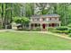 Charming two-story home featuring a welcoming front porch, red shutters, and a beautifully landscaped front yard at 5507 Martina Way, Dunwoody, GA 30338