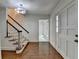Bright foyer with hardwood floors, staircase and view to the front living space at 5507 Martina Way, Dunwoody, GA 30338