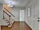Bright foyer features hardwood floors, a staircase with carpet runner, and traditional design details at 5507 Martina Way, Dunwoody, GA 30338